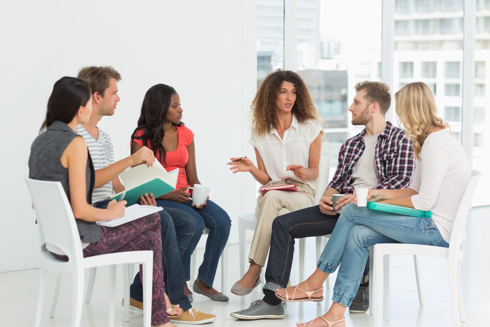 Female thought leader holding a discussion group.