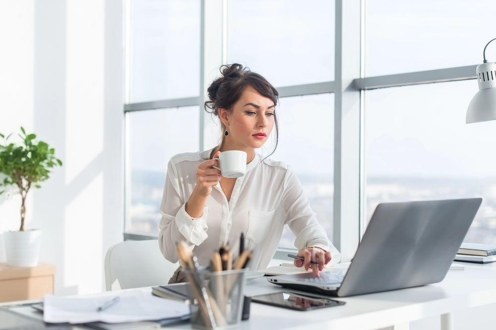 Female thought leader typing on laptop