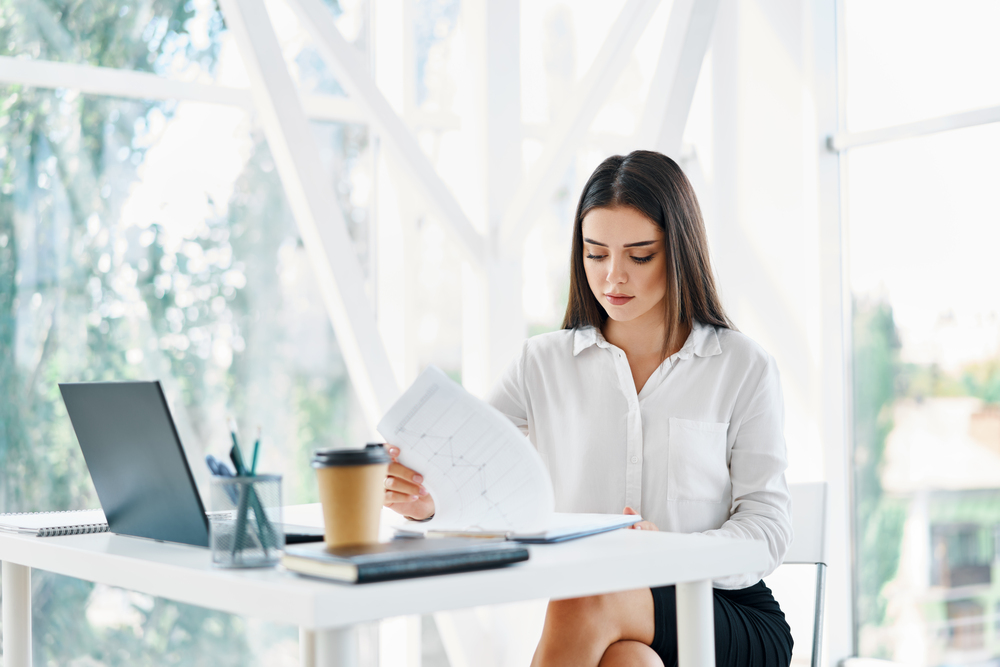 Content repurposing by a woman sitting at a desk