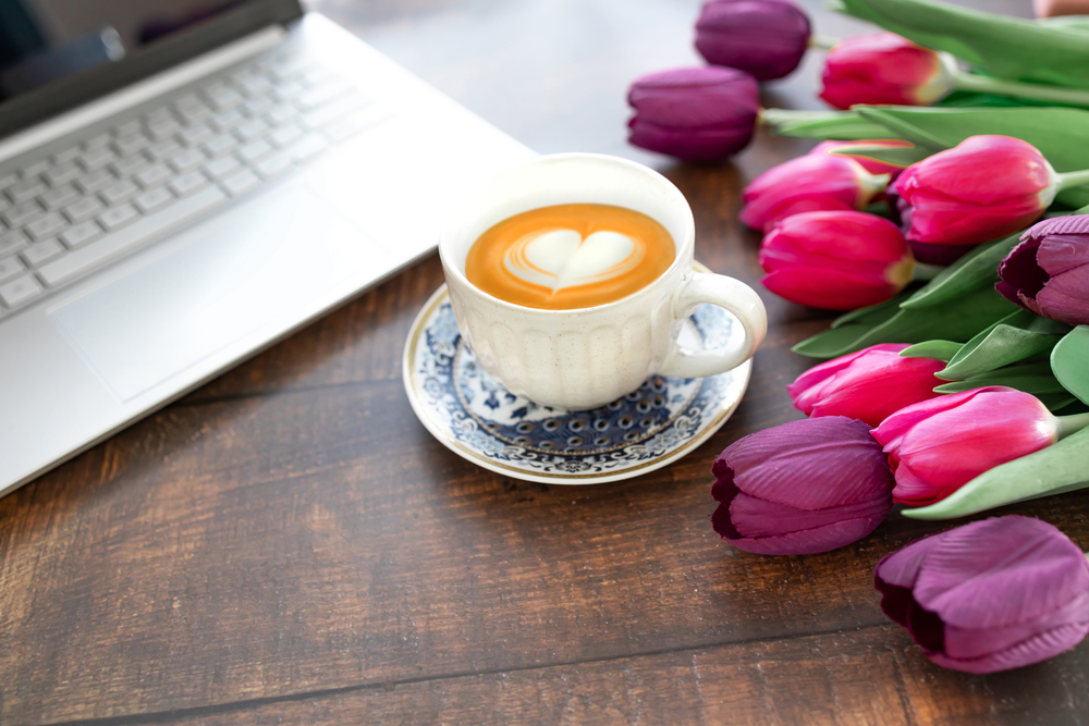 Laptop with coffee and flowers