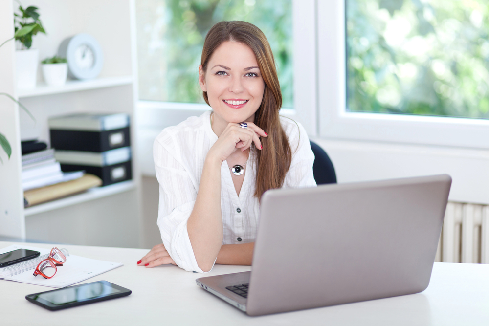 woman at laptop repurposing content