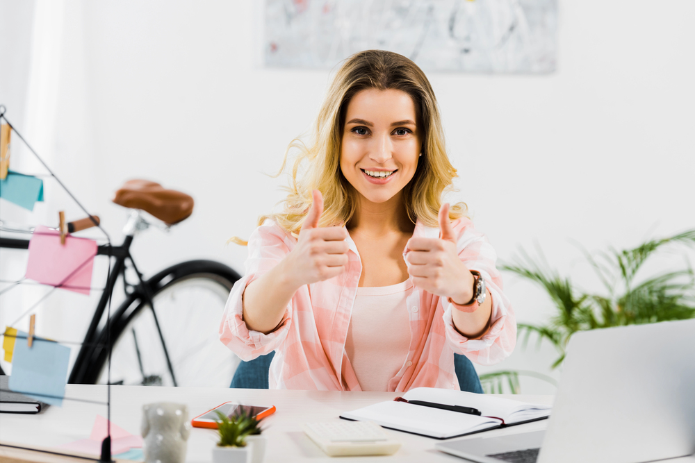 woman demonstrating authentic leadership with gratitude giving the thumbs up