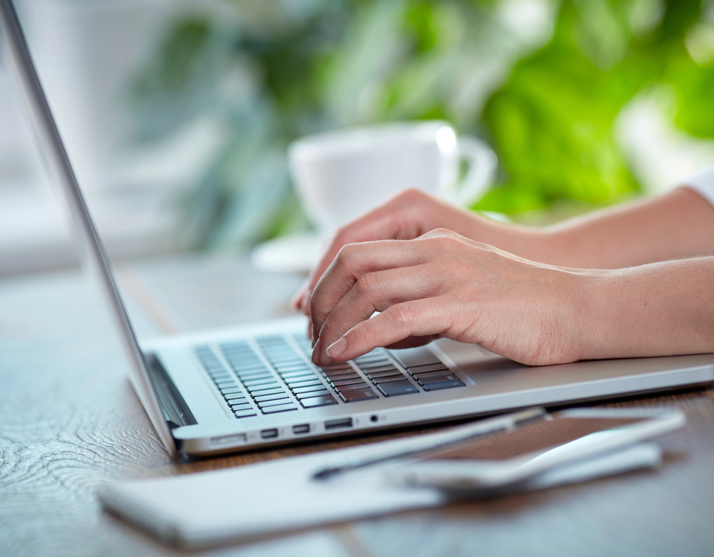 unknown person (ghostwriter) typing on laptop