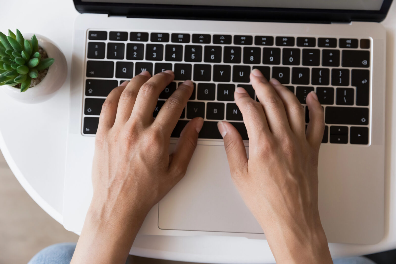 woman typing business content on laptop